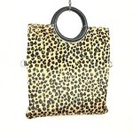 Bolso de piel artesanal con pero y asas circulares para mujer